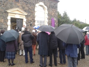People gather outside the meeting house in anticipation of the unveiling of the blue plaque
